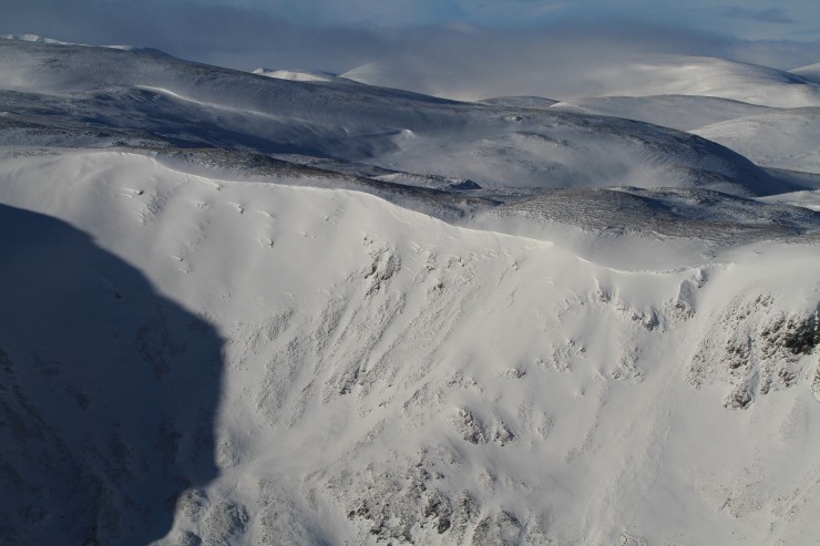 Wind lips and cornices have built up over lee slopes.