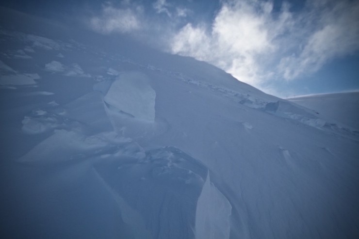 Cornice and avalanche debris with continuous drifting onto the face.
